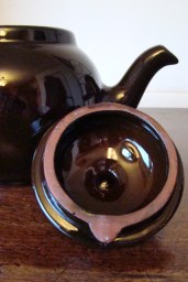 Brown Betty teapot showing unglazed red clay rim