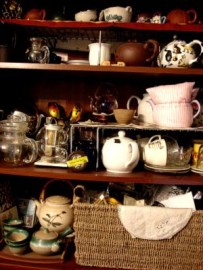 Shelves overflowing with tea and tea ware.
