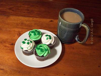 Chocolate cupcakes with green and white icing and shamrock sprinkles are perfect for your St. Patty’s Day tea time