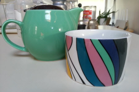 My borrowed teawares: a Bee House teapot and colourful little mug (photo is mine).