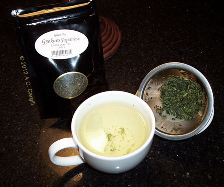 The dark green leaves steep up a pale yellow-green liquid.