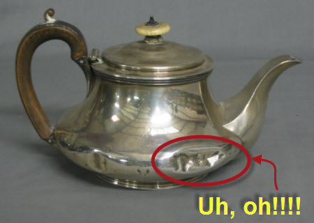 A dented silver teapot — victim of a fracas? (Yahoo! Images)